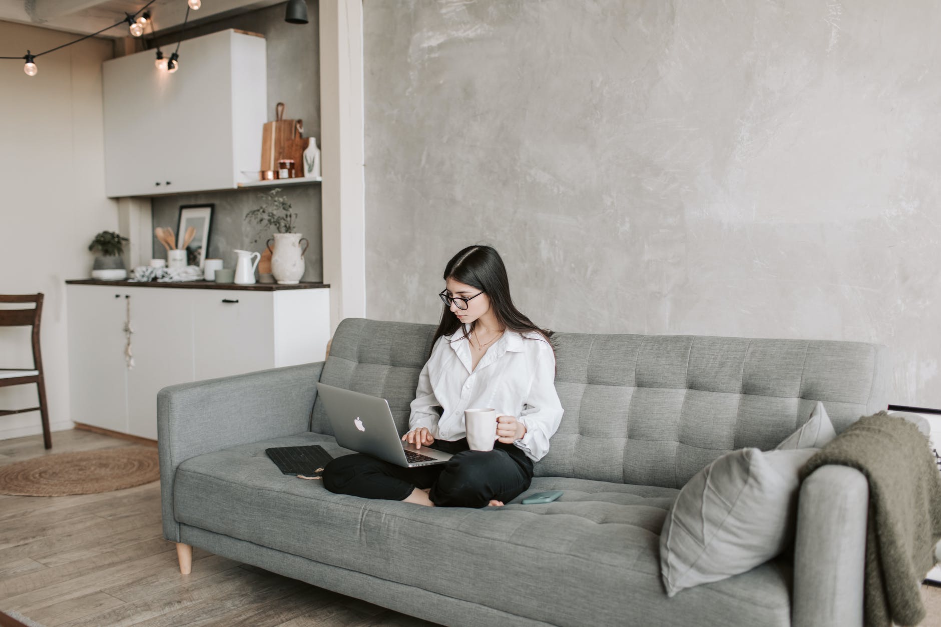 pexels-photo-4050295 woman sitting on sofa while working at home