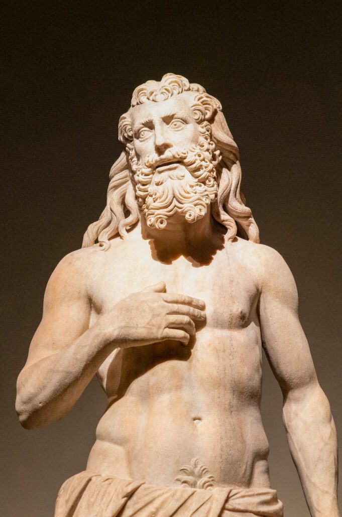 statue of zeus in close up photography