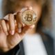 a person holding gold coin